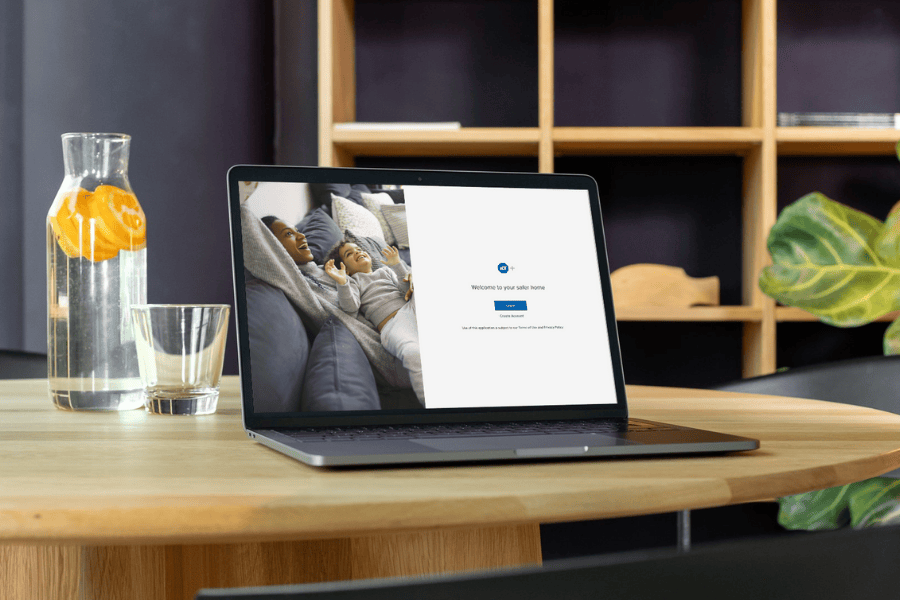 laptop on a table with the ADT plus login screen